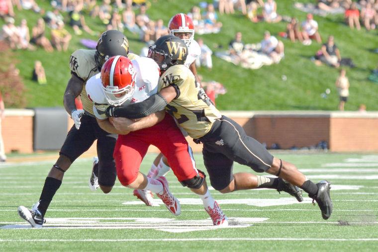 Redshirt junior quarterback Pete Thomas is tackled after running an option play during the football game against Wake Forest at BB&amp;T Field in Winston-Salem on Oct. 5. The Demon Deacons defeated the Wolfpack, 28-13.