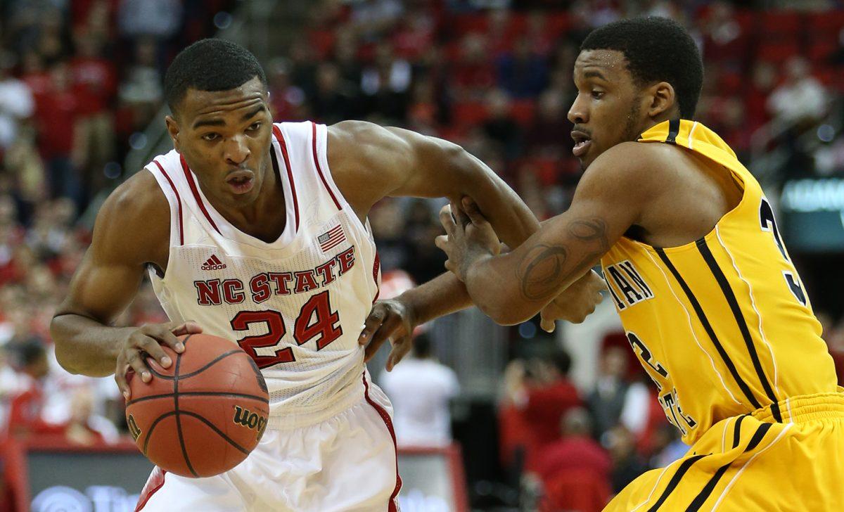 N.C. State sophomore forward T.J. Warren drives around App State freshman guard Ty Toney during the season opening game between N.C. State and Appalachian State University in PNC Arena Friday, Nov. 8, 2013. The Wolfpack defeated the Mountaineers 98-77. Photo by John Joyner.