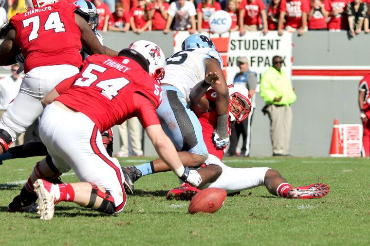 Redshirt sophomore center Joe Thuney recovers a fumble by graduate quarterback Brandon Mitchell during the second quarter of the homecoming game against Carolina Saturday, Nov. 2 2013 in Carter-Finley Stadium. The Wolfpack had a total of three fumbles during the game against the Tar Heels.