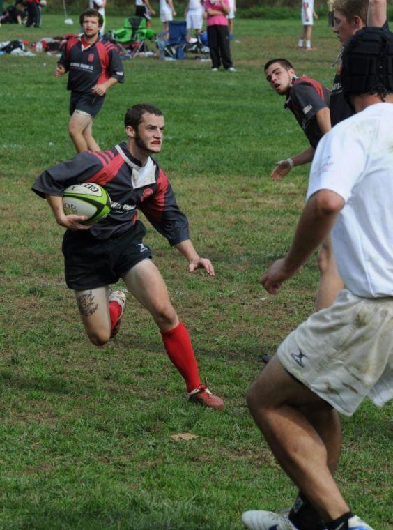 Senior scrumhalf Hayden Knight carries the ball in a match against the Elon Phoenix on Oct. 27, 2012.