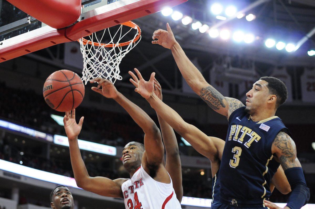 Sophomore forward T.J. Warren jumps as he loses the ball to Pittsburgh's redshirt junior guard Cameron Wright Nov. 4, 2014 at PNC Arena. The Wolfpack lost to the Panthers 74-62. Photo by Ryan Parry.