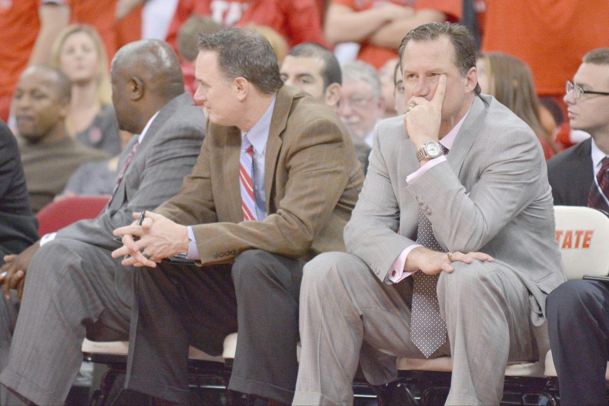 Head coach Mark Gottfried watches the closing minutes of the game unfold during the game against Virginia in PNC Arena Saturday, Jan. 11, 2014. The Wolfpack fell to the Cavaliers, 76-45, in their worst ever loss in PNC Arena. Photo by John Joyner.