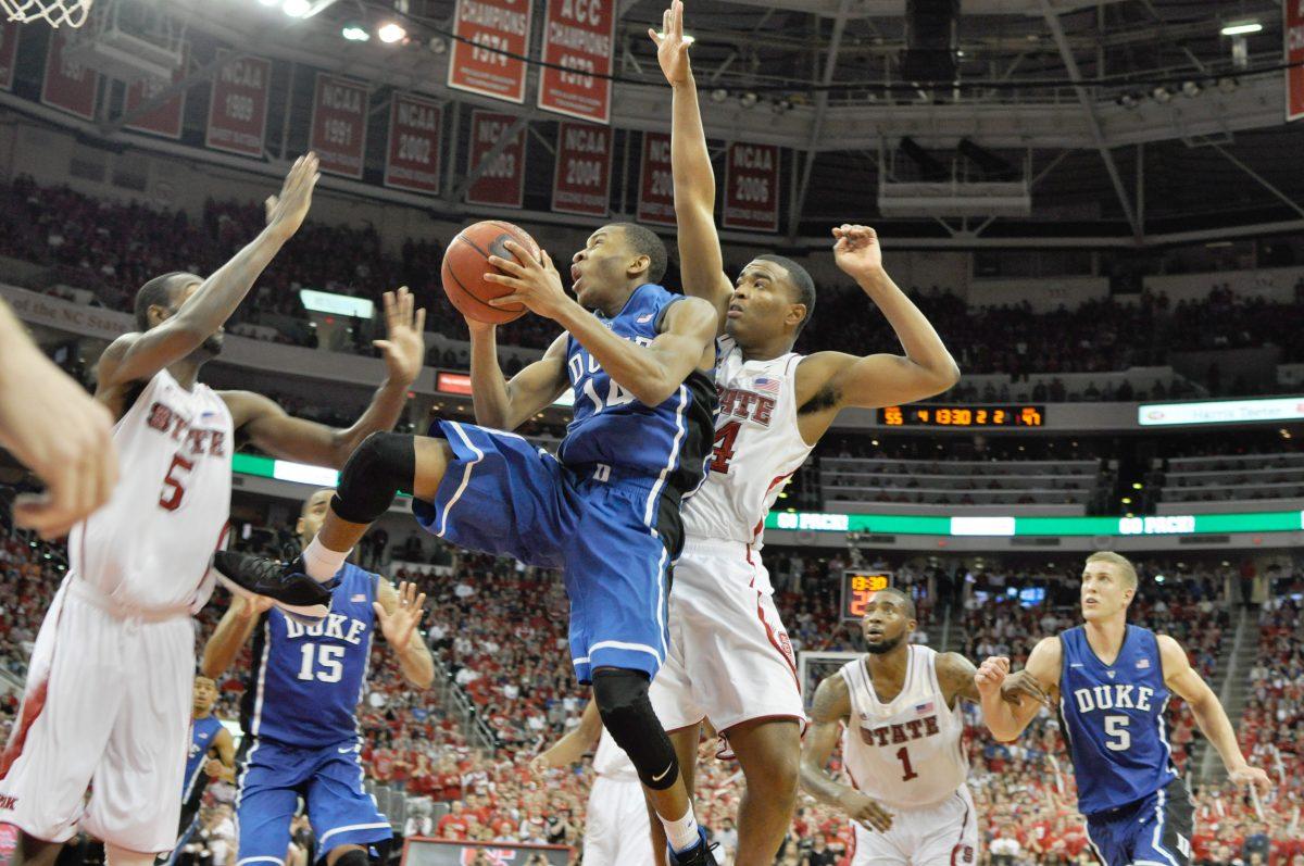 Duke's freshman guard Rasheed Sulaimon shoots under pressure from N.C. State's freshman guard T.J. Warren and junior forward C.J. Leslie at PNC Arena on Jan. 12, 2013. The No. 20 Wolfpack defeated the No. 1 and previously undefeated Wolfpack 84-76. Photo by Chris Rupert