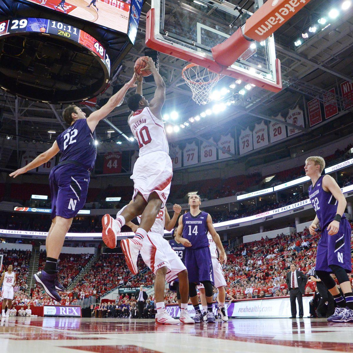 Freshman forward Lennard Freeman jumps to dunk the ball during the game against Northwestern Wednesday, Dec. 4, 2013. Freeman had 10 points and 10 rebounds in the Wolfpack's 69-48 win against the Wildcats at PNC Arena. Photo by Ryan Parry.