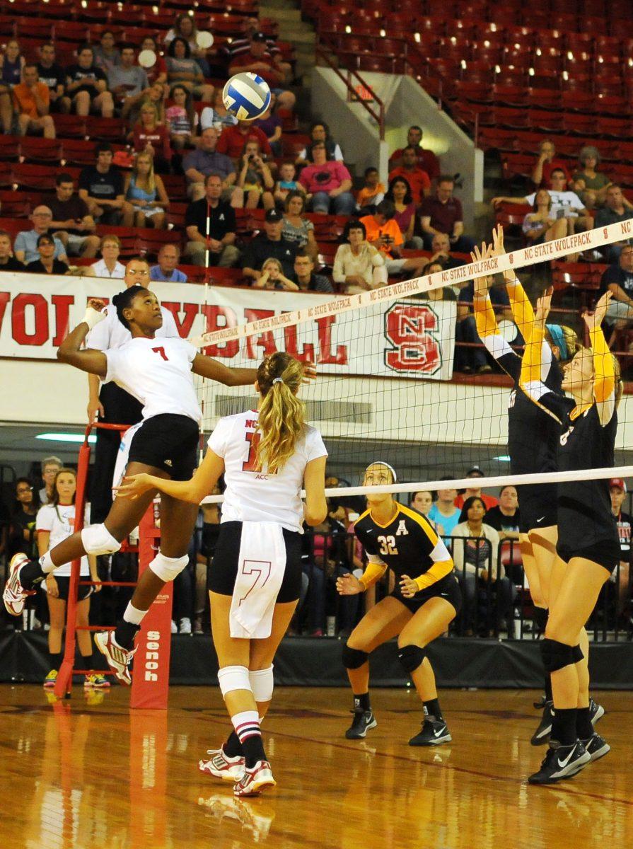 Senior middle blocker Brie Merriwether spikes the ball against Apalachian State Friday, September 6, 2013. Merriwether had 10 kills in the Wolfpack's 3-0 win over the Mountaineers during the first game of the Courtyard Midtown Classic at Reynolds Coliseum. Photo by Ryan Parry.