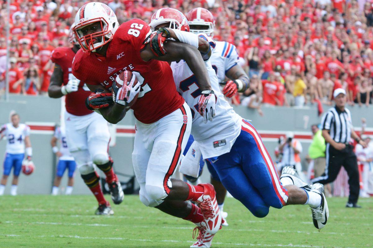 Graduate student Asa Watson runs the football Saturday, Aug. 31, 2013 at Carter-Finley Stadium against Louisiana Tech. The Wolfpack defeated the Bulldogs 40-14. Photo by Chris Rupert