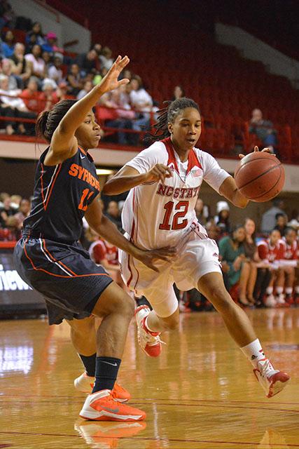 Junior guard Krystal Barrett drives to the basket during the Wolfpack&#8217;s conference opener against Syracuse on Sunday. Barrett racked up 10 points and three assists in the N.C. State&#8217;s 67-61 victory over the Orange.