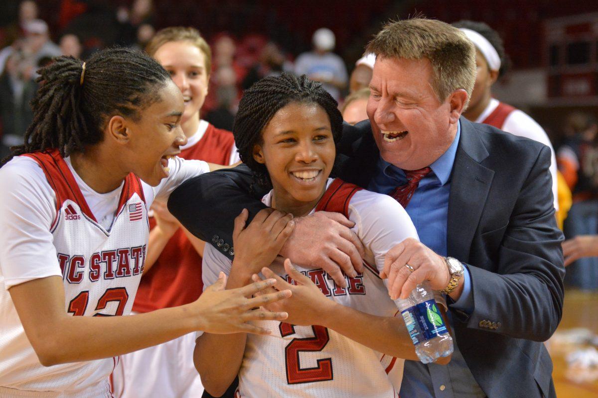 Head coach Wes Moore celebrates with redshirt junior guards Len&#8217;Nique Brown and Krystal Barrett during the game against No. 8 Maryland in Reynolds Coliseum on Thursday. The No. 18 Wolfpack defeated the No. 8 Terrapins, 72-63.&#160;