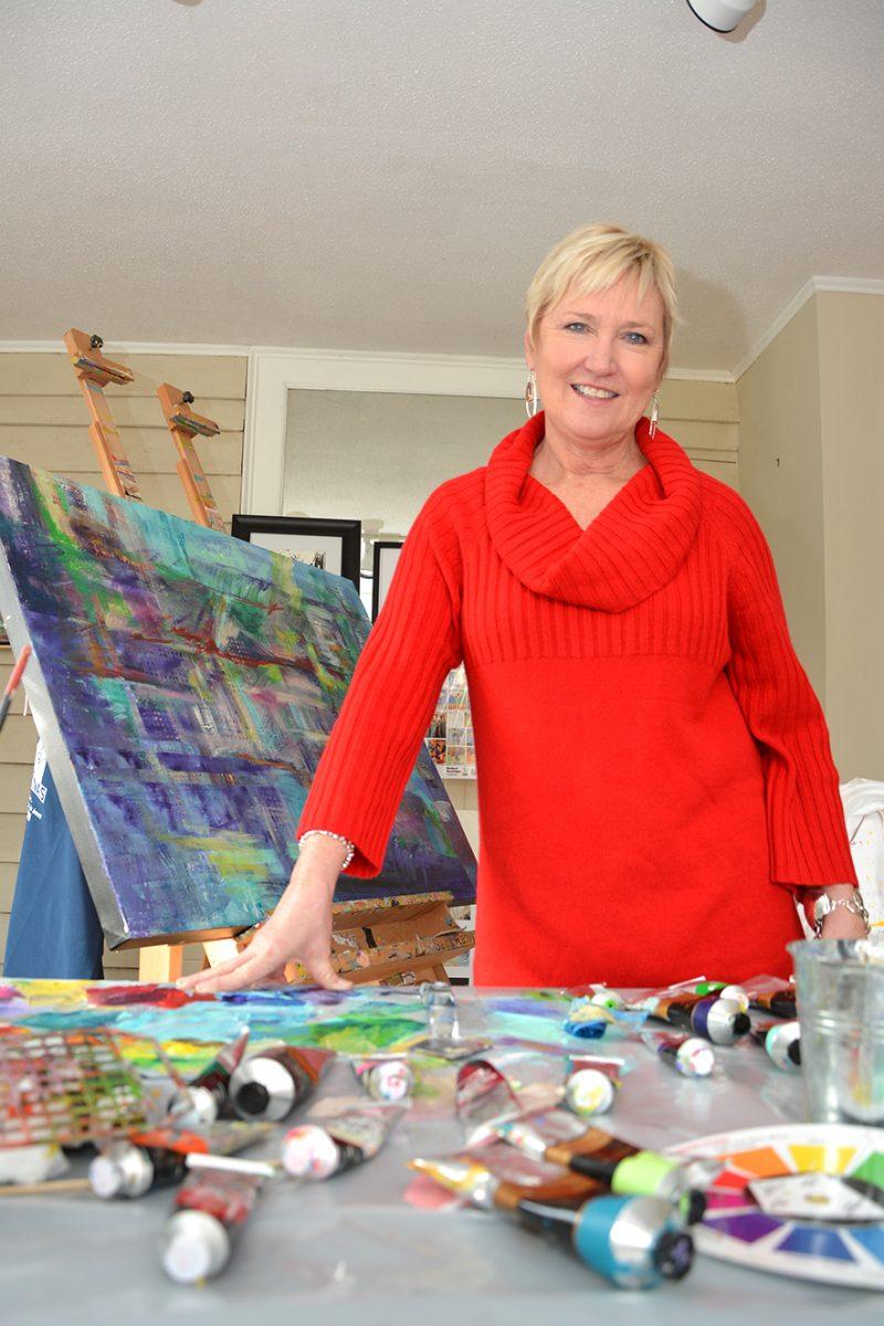 Susan Woodson, owner and founder of the Roundabout Art Collective on Oberlin Street, poses in her studio Dec. 7. Woodson, wife of Chancellor Randy Woodson founded the Art Collective in 2010.