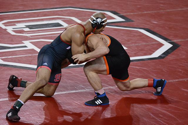 Redshirt senior KaRonne Jones (197) attempts to pin his opponent. Jones scored a 6-5 victory to help N.C. State beat Campbell, 34-10, during the Beauty and the Beast meet in Reynolds Coliseum on Friday, Jan. 24, 2014.