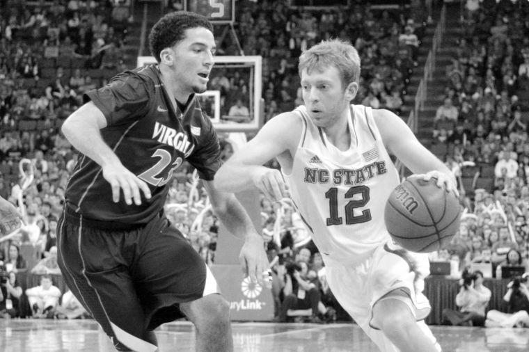 Sophomore guard Tyler Lewis drives into the paint during the game against Virginia in PNC Arena on Jan. 11. The Wolfpack fell to the Cavaliers, 76-45, in its worst ever loss in PNC Arena.&#160;