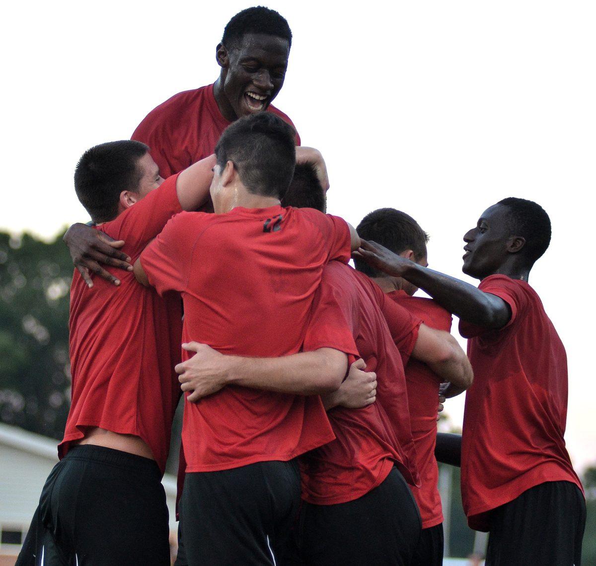 The N.C. State men's soccer team celebrates after a goal by junior defenseman Clement Simonin during the first half of their matach against UNC-Wilmington Saturday, August 24, 2013. The Wolfpack tied the Seahawks 1-1 during their exhibition match at Dail Soccer Stadium.&#160;