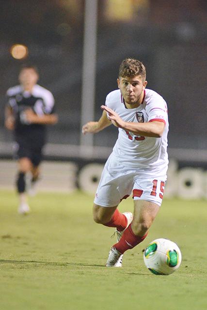 Senior midfielder Alex Martinez drives down the field during soccer match against new Davidson at Dail Soccer Field Sept. 24, 2013. The Wolfpack defeated the Wildcats 2-0.&#160;