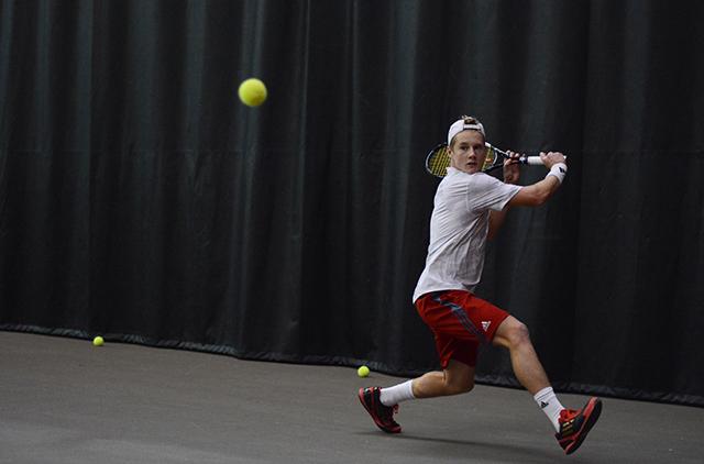 Freshman Nick Horton backswings before hitting the ball. Horton won in the second set over his UNC Greensboro opponent. NC State crushed the Spartains 7-0 in the J.W. Isenhour Tennis Center Sat., Jan. 18, 2014. Photo by Joseph Phillips