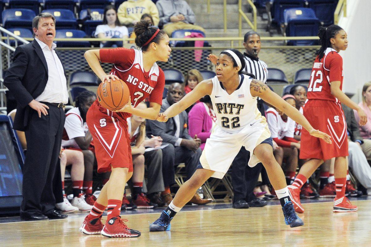 Freshman guard Miah Spencer protects the ball as N.C. State head coach Wes Moore shouts instructions from the sideline Thursday night at the Petersen Events Center in Pittsburgh. Spencer poured in 14 points, helping the Wolfpack beat the Panthers, 79-68. The Pack&#8217;s win over Pitt was also the 800th win in N.C. State program history.