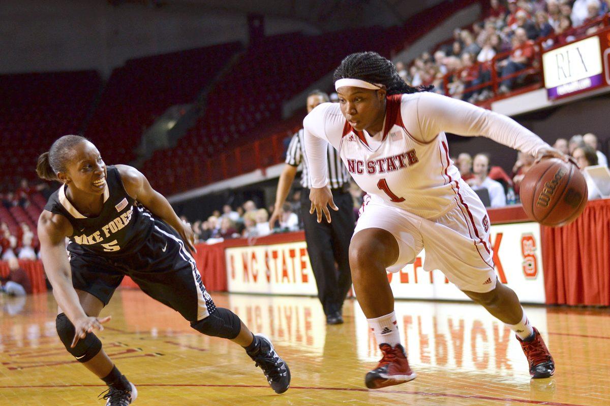Senior guard Myisha Goodwin-Coleman drives past Wake Forest&#8217;s senior guard Chelsea Douglas Thursday night in Reynolds Coliseum. Goodwin-Coleman scored 16 points against the Demon Deacons, becoming the 30th player in program history to score more than 1,000 points during her N.C. State career. The No. 14 Wolfpack women defeated the Demon Deacons, 74-69, taking State&#8217;s record to 20-3 on the season.