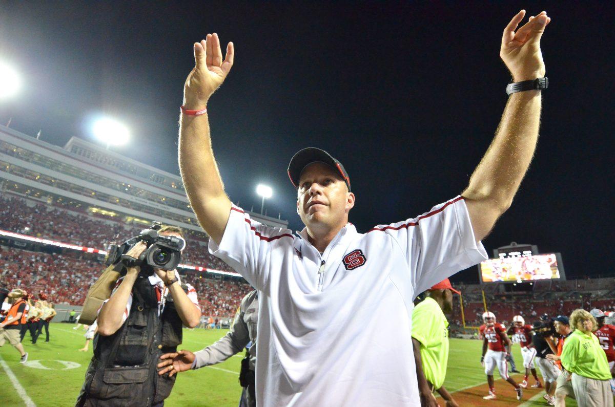 N.C. State head coach Dave Doeren makes the Wolfpack sign to the student section as he leaves field after State&#8217;s football game against the University of Richmond in Carter-Finley Stadium Saturday, Aug. 31. The Wolfpack narrowly defeated the Spiders, 23-21, thanks to a 48-yard field goal from junior kicker Niklas Sade with 0:33 left in the game.