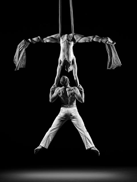 Famed circus artists Alexander Stretskov and Christine Van Loo perform in Cirque de la Symphonie. The two are photographed during their aerial duo performance.