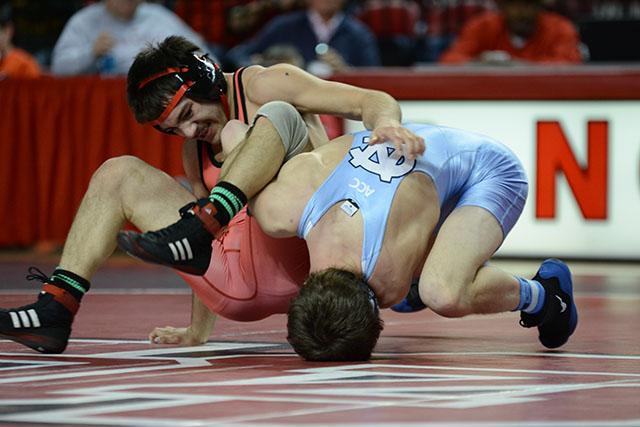 Freshman Micah Perez slams UNC-Chapel Hill&#8217;s sophomore Nathan Kraisser down on his head, but Perez was beaten by Kraisser. N.C. State defeated the Tar Heels, 19-16, in the ACC dual Jan. 31 in Reynolds Coliseum.