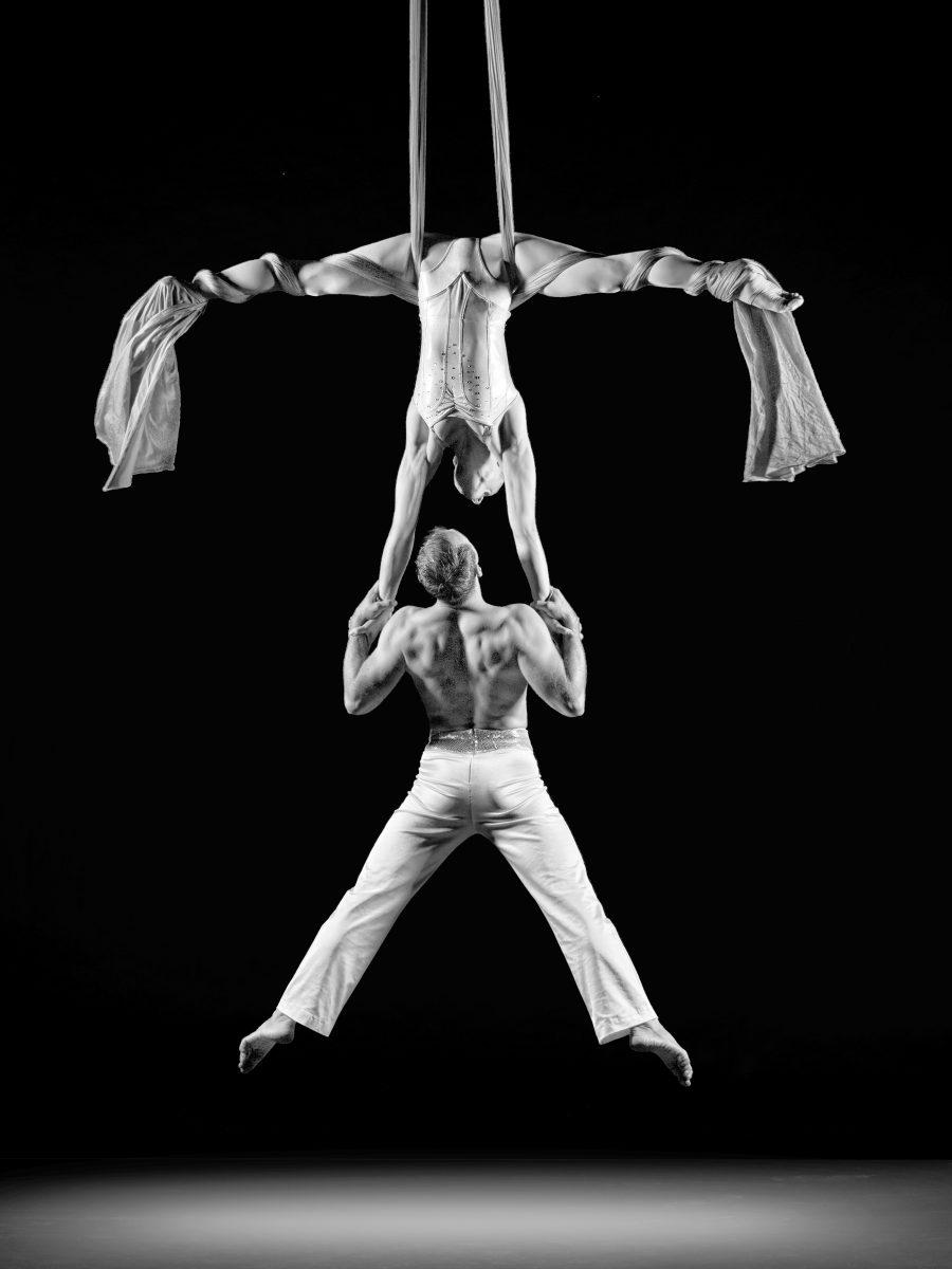 Famed circus artists Alexander Stretskov and Christine Van Loo perform in Cirque de la Symphonie. The two are photographed during their aerial duo performance.