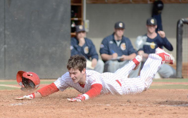 Junior outfielder Jake Fincher slides into home plate Monday against Canisius at Doak Field. The Wolfpack bounced back from a loss on Sunday to the Golden Griffins and defeated Canisius, 11-4, Monday afternoon.