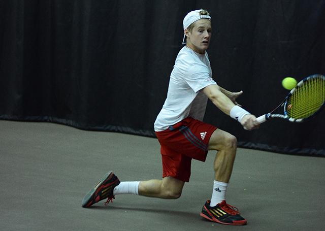 Freshman Nick Horton stretches for a backhand against UNC-Greensboro during the second set of his match on Jan. 18, 2014 at the J.W. Isenhour Tennis Center. Horton won his match 6-2, 6-2 and helped N.C. State defeat the Spartans, 7-0.