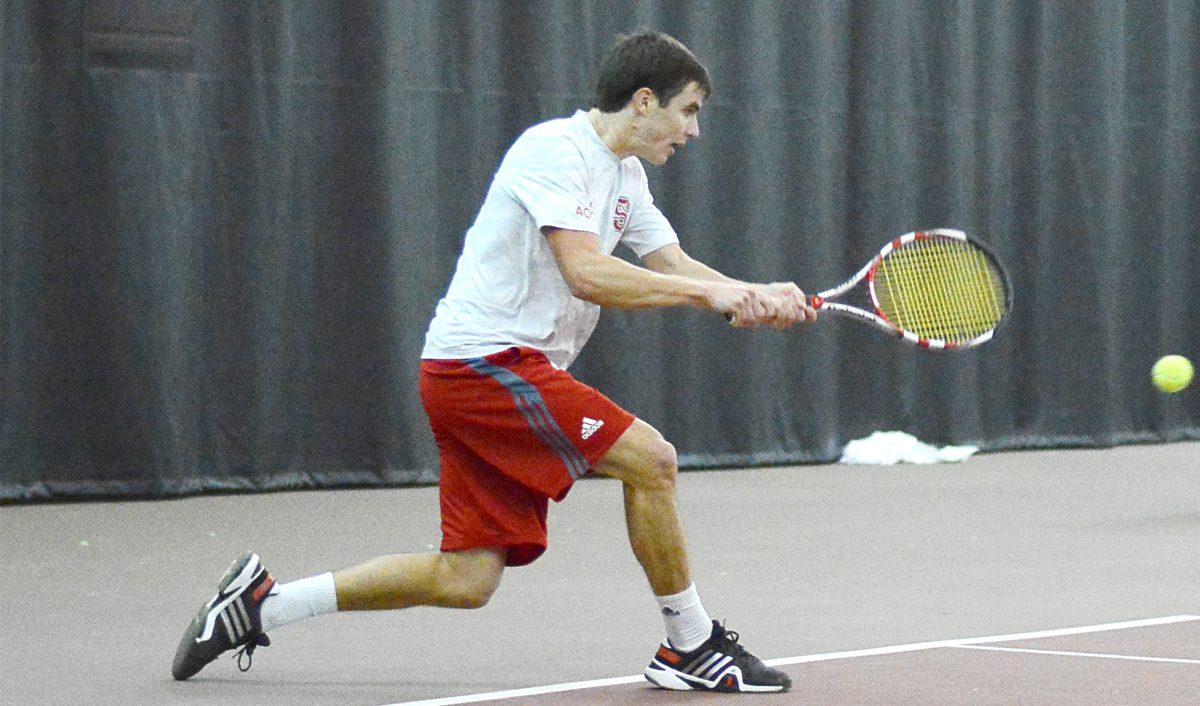Junior Robbie Mudge hits a backhand in his singles match against junior Randy Phillips from UNC-Greensboro Jan. 19. Mudge defeated Phillips, 6-3, 6-1, and also won his doubles match with freshman Ian Dempster, defeating their opponents, 6-2. Mudge&#8217;s pair of wins helped N.C. State defeat the Spartans, 7-0.