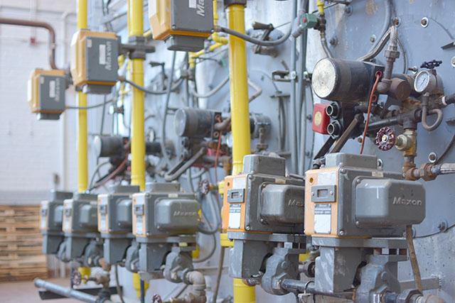 One old boiler remains at the plant, still producing energy for campus over half a century after installation. Photo by Caide Wooten.