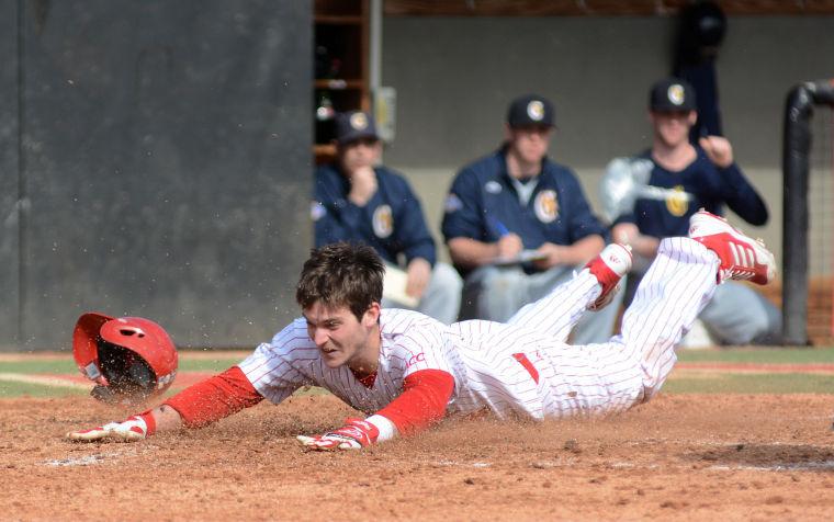 Junior outfielder Jake Fincher slides into home plate Feb. 17 at Doak Field against Canisius. The Wolfpack defeated Canisius, 11-4, finishing the series 1-1.&#160; Fincher finished the day two-for-three at the plate with one run.