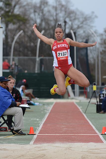 Sophomore Alexis Perry jumps into the sand pit for long jump. Perry grabbed first place in the women&#8217;s 100-meter hurdles with a personal best time of 13.39. N.C. State track &amp; field team competed in the 2014 Raleigh Relays at Paul Derr Track Friday.
