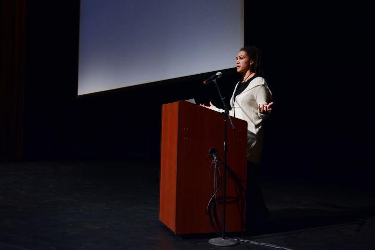 Ch&#233;rie Rivers Ndaliko, assistant professor in the Music Department at the University of North Carolina Chapel Hill, explains what the Congo is actually like. She showed several music videos from the Congo on an album called "Art from the Front Line". Ch&#233;rie said that "If you are anything like me, you would rather hear music than listen to a lecture" in Titmus Theatre Friday, Feb 28, 2014. Photo by Joseph Phillips