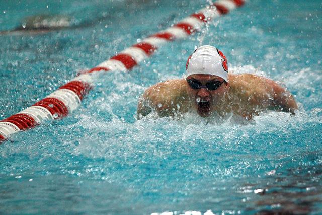 Senior Barrett Miesfeld powers his way toward the wall during the 100-yard butterfly Feb. 1. at the Willis R. Casey Aquatic Center. Miesfeld finished first with a time of 47.10 as the NCSU men squeaked out a win against the Cavaliers, 157-141.