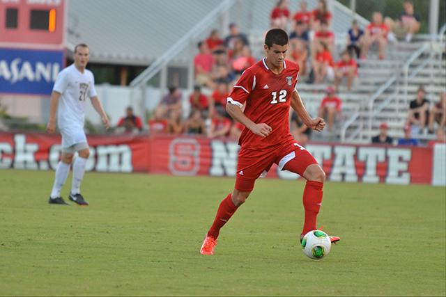 Sophomore midfielder Holden Fender dribbles across the pitch during N.C. State&#8217;s ACC opener against Pittsburgh at Dail Soccer Field Sept. 6, 2013. The Wolfpack beat the Panthers in overtime, 1-0.
