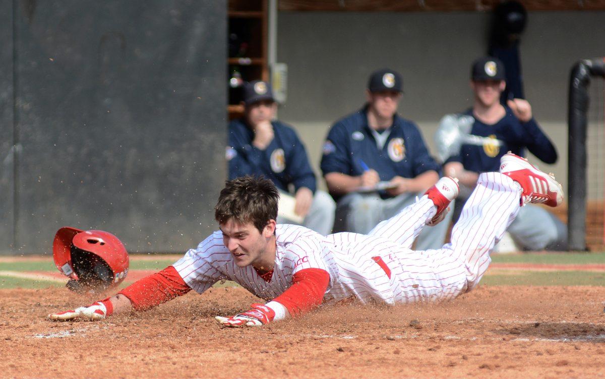 Junior outfielder Jake Fincher slides into home plate Feb. 17 at Doak Field against Canisius. The Wolfpack defeated Canisius, 11-4, finishing the series 1-1.&#160; Fincher finished the day two-for-three at the plate with one run.