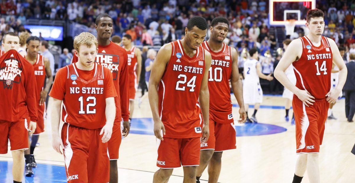 N.C. State players, from left, Tyler Lewis (12), T.J. Warren (24), Lennard Freeman (10) and Jordan Vandenberg (14) walk off the court after Saint Louis' 83-80 overtime victory over the Wolfpack in the second round of the NCAA Tournament at the Amway Center in Orlando, FL, Thursday, March 20, 2014.