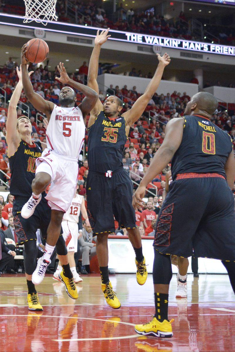 Freshman guard Rodney Purvis jumps up to dunk the ball during the game against Boston College in PNC Arena Wednesday, Feb. 27, 2013. The Wolfpack defeated the Eagles 82-64, for a total of 20 wins on the season. Photo by John Joyner.Junior guard Desmond Lee goes for a layup between two Maryland defenders during a game on Jan. 20.