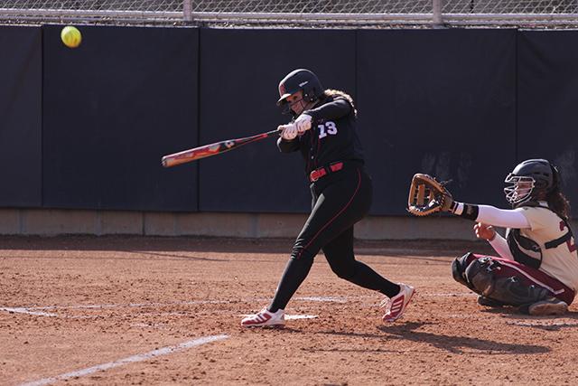 Junior left fielder Sara Lippard rips a fly ball into left field during N.C. State&#8217;s 13-5 win over Elon University Mar. 26 at the Dail Softball Stadium.