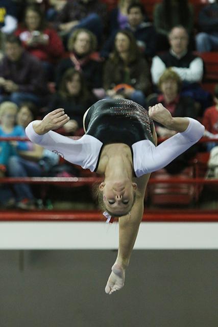 Senior Stephanie Ouellette executes a front flip on the balance beam Jan. 17. in Reynolds Coliseum. The Wolfpack took second place with 195.650 points to the University of Michigan, beating UNC-CH by 3.2 points. Ouellette scored a 9.850 on the balance beam.