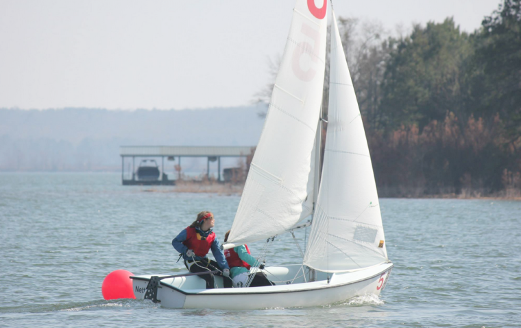 Senior skipper Paulina Spencer and junior crew Jill Tucker round the windward mark at SAISA North Points No. 2 Regatta at Clemson University.