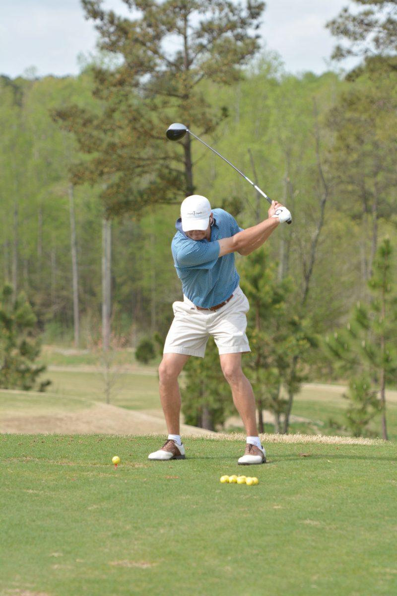 Senior Logan Harrell practices his swing on the range at N.C. State&#8217;s Lonnie Poole Golf Course April 14.
