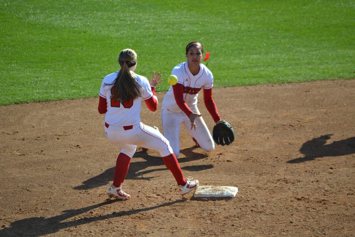 Junior shortstop Renada Davis and senior second baseman Chelsea Tate attempt to turn a double play during a 5-2 win over Virginia March 1.