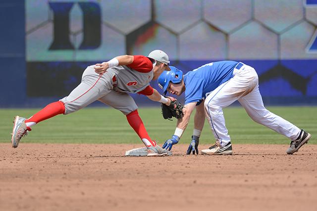 Junior infielder Logan Ratledge reaches to tag a player out during the baseball game against Duke Saturday in Durham Bulls Athletic Park.