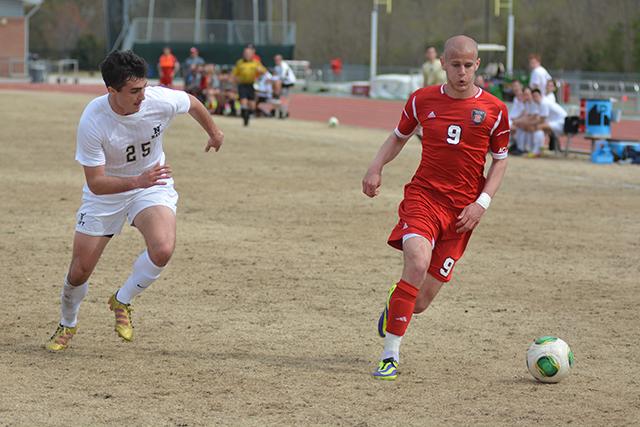 Redshirt junior forward Nick Surkamp dribbles past Navy defender Michael Parker at Dail Soccer Stadium Saturday afternoon April 5, 2014. Despite a late goal in the second half, the Wolfpack dropped the scrimmage match 2-1. Photo by Caide Wooten.