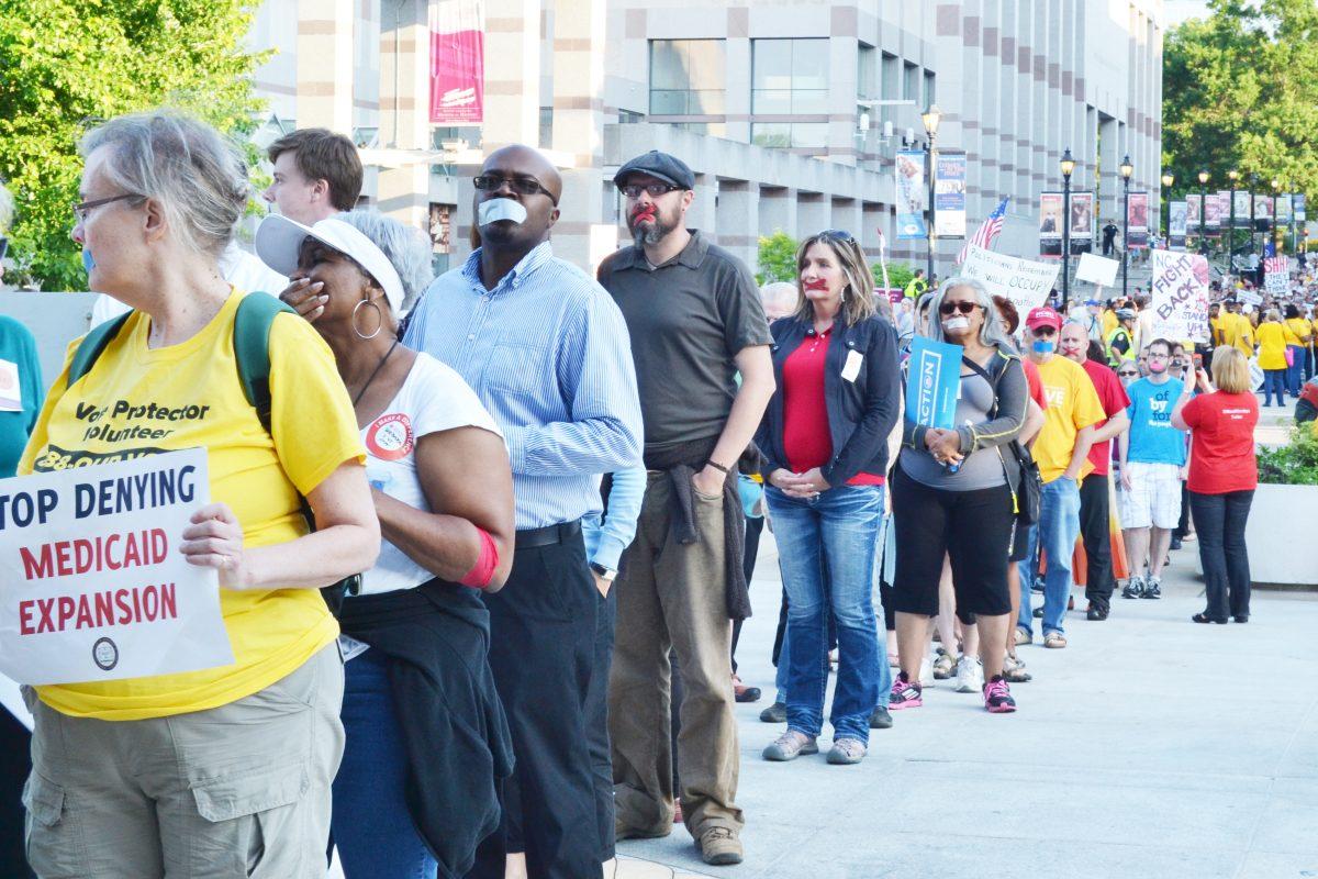 Thousands of Moral Monday protestors line up to enter the N.C. General Assembly&#8217;s Legislative Building Monday.&#160; They walked through the building silently with tape over their mouths.