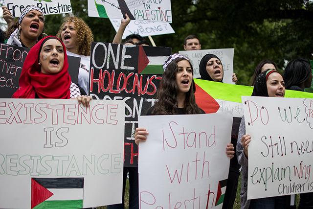 (From left to right) Sara Dahbour, Danyah Dahbour, and Khadija Ewais shout at passing cars on Morgan St. in support of the liberation of Palestine at the State Capitol Building Saturday afternoon.&#160;
