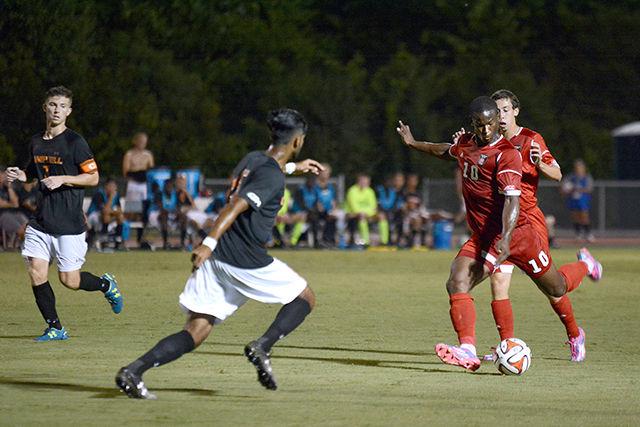 Freshman forward Ade Taiwo shoots the ball during the NC State's game against Campbell Aug. 20, 2014. The Wolfpack defeated the Camels 2-0 at Dail Soccer Field.&#160;