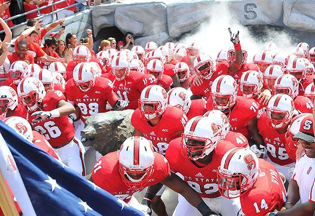 The N.C. State football team rushes out of the locker room tunnel before the start of last year's opening game against Louisiana Tech.