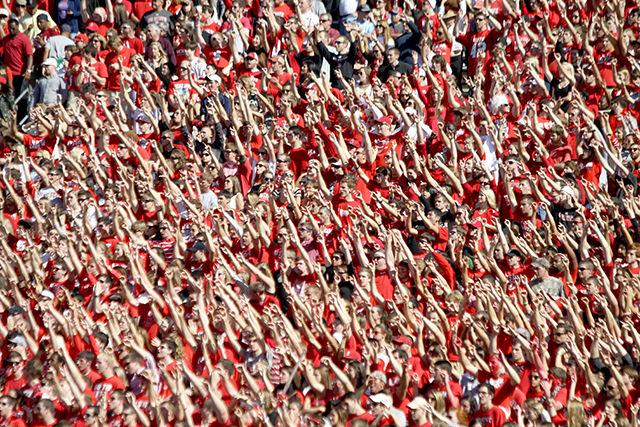 N.C. State fans put up the wolf symbol during the football game on Nov. 2, 2013 in Carter-Finley Stadium against UNC-Chapel Hill.