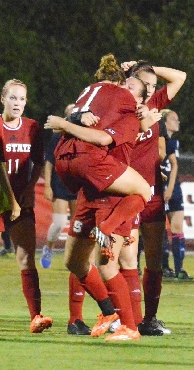 The Womens' soccer team celebrates their narrow victory over UNC Wilmington. The Wolfpack squeaked out a 2-1 victory over the Seahawks this past Friday. Photo taken 22 August 2014 by Brennen Guzik
