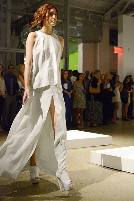 One of LeBlanc's models displays a loose flowing gown with a slit as she walks through the Contemporary Art Museum in Raleigh Thursday, Aug. 28, 2014. This is one of the seven outfits that LeBlanc presented as part of his spring/summer 2015 collection.&#160;